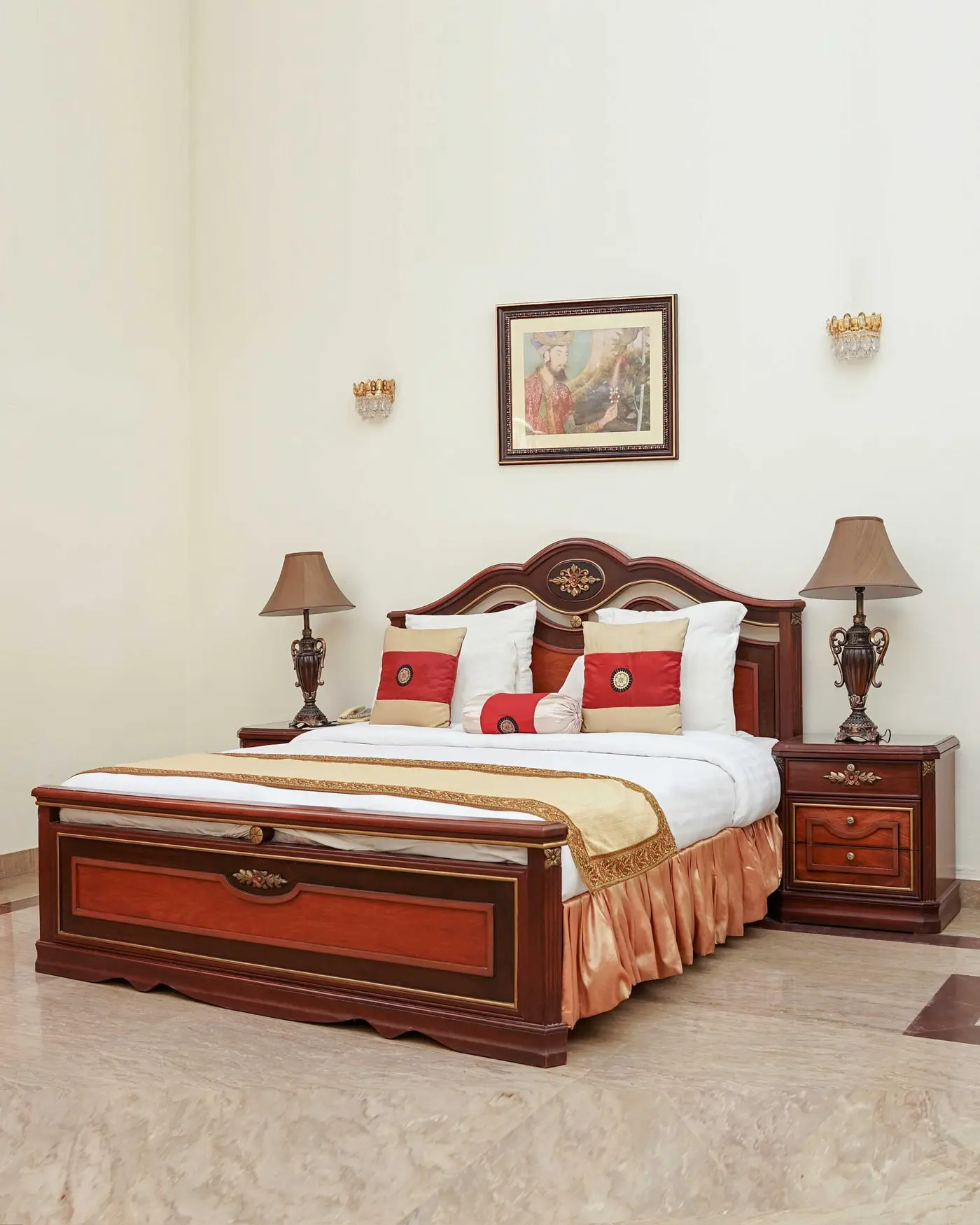 Standard Room at Etihad Club, with a mahogany bed against cream walls