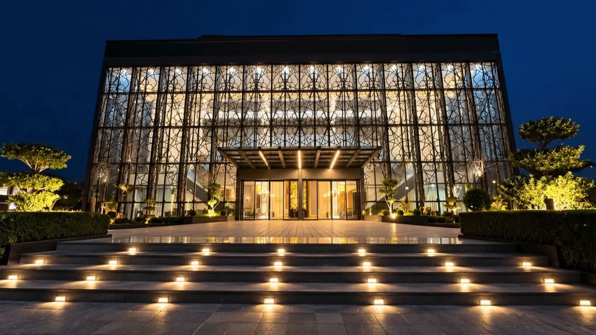 The glass frontage of Faletti’s Banquet Divine Garden at night, above a broad flight of lit steps