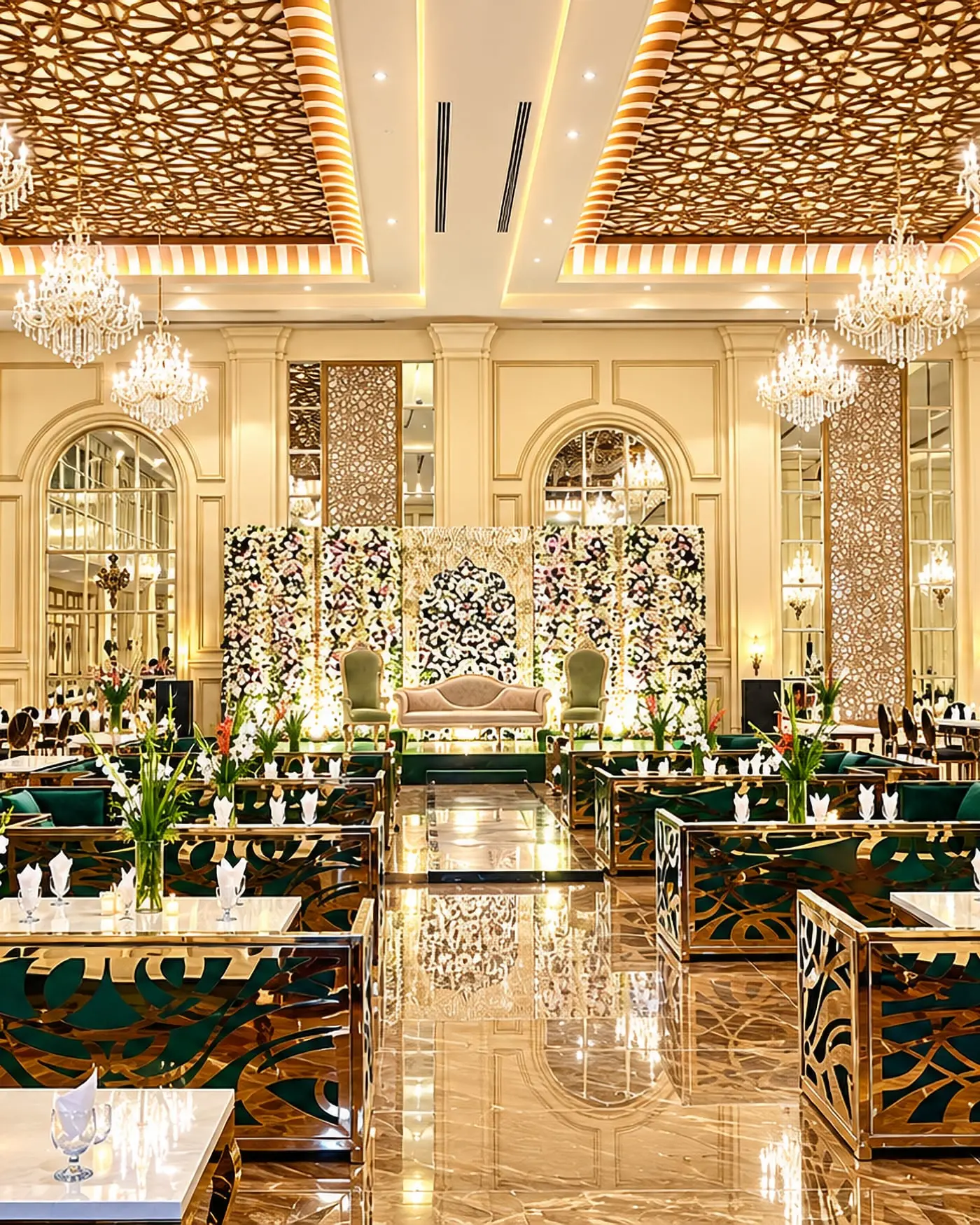The banquet hall at Faletti’s Banquet Divine Garden, chandeliers above green velvet seating