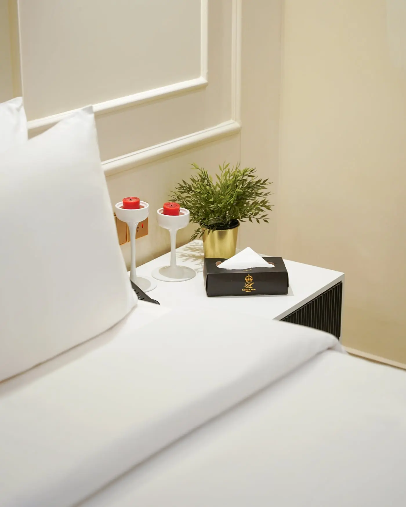 A dressed bed and bedside tray