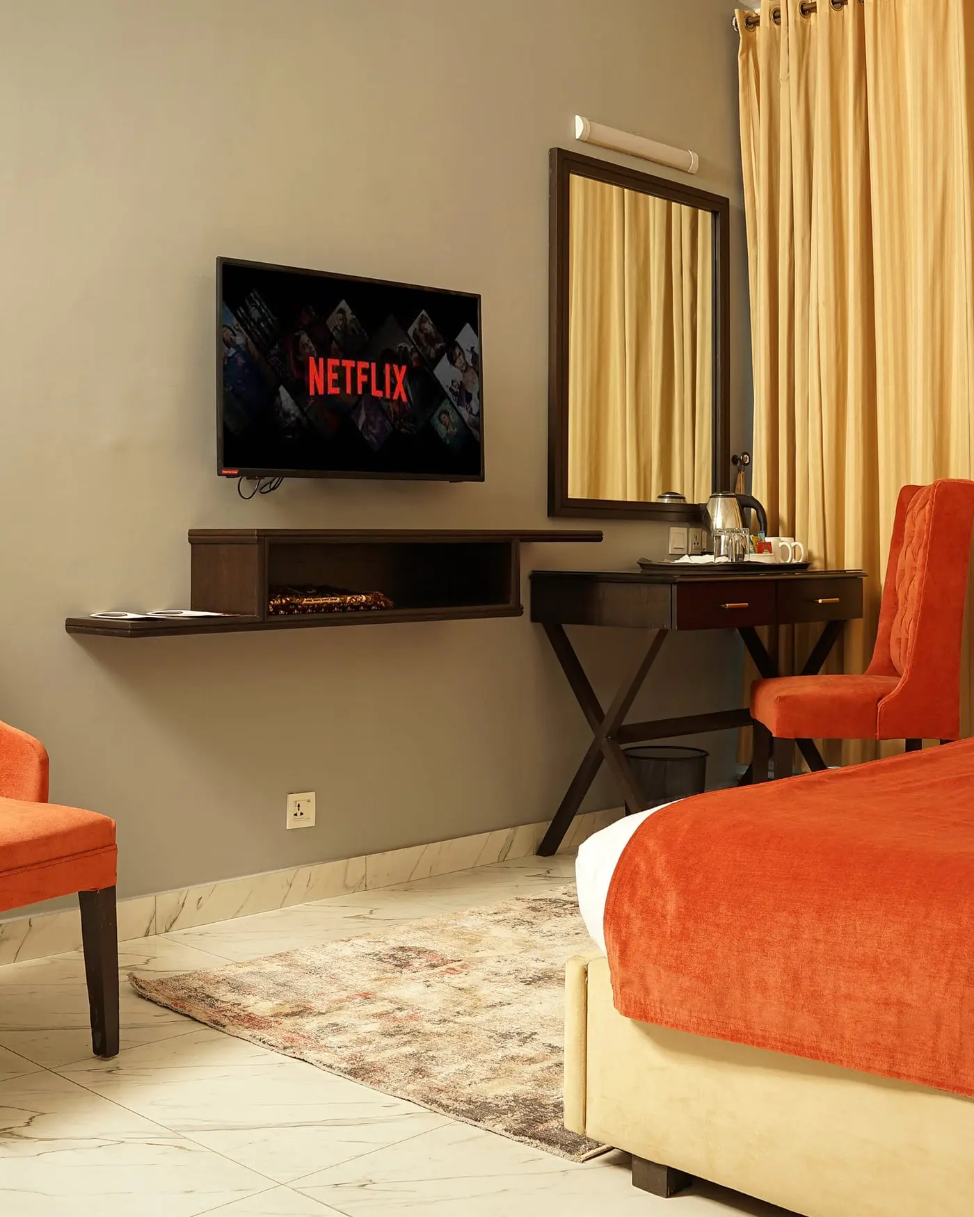 An executive room at Faletti’s Grand Gulberg, with a work desk and a wall-mounted television