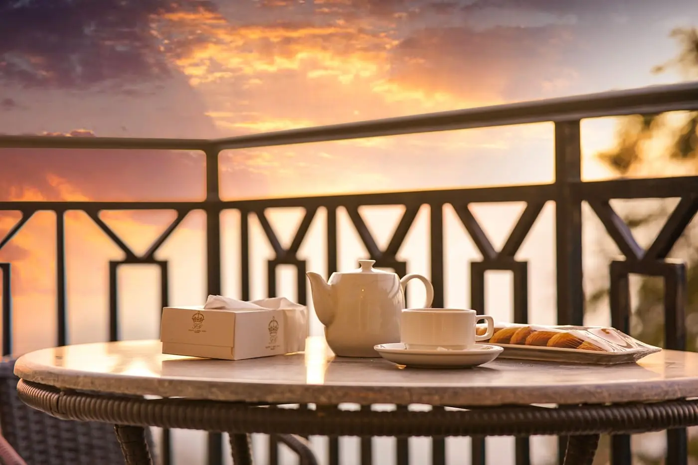 Tea served on a balcony at sunset