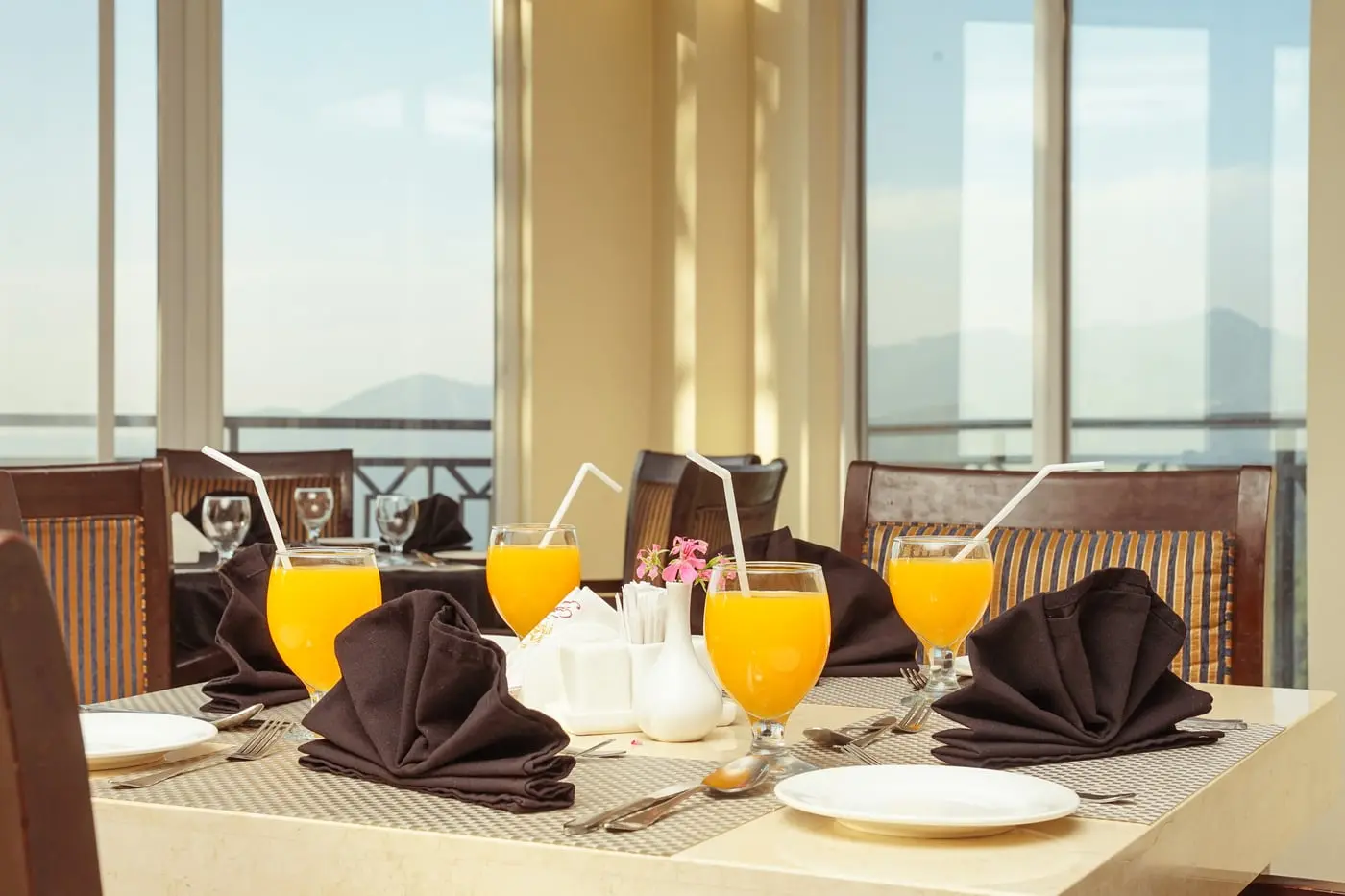 A breakfast table laid by the window