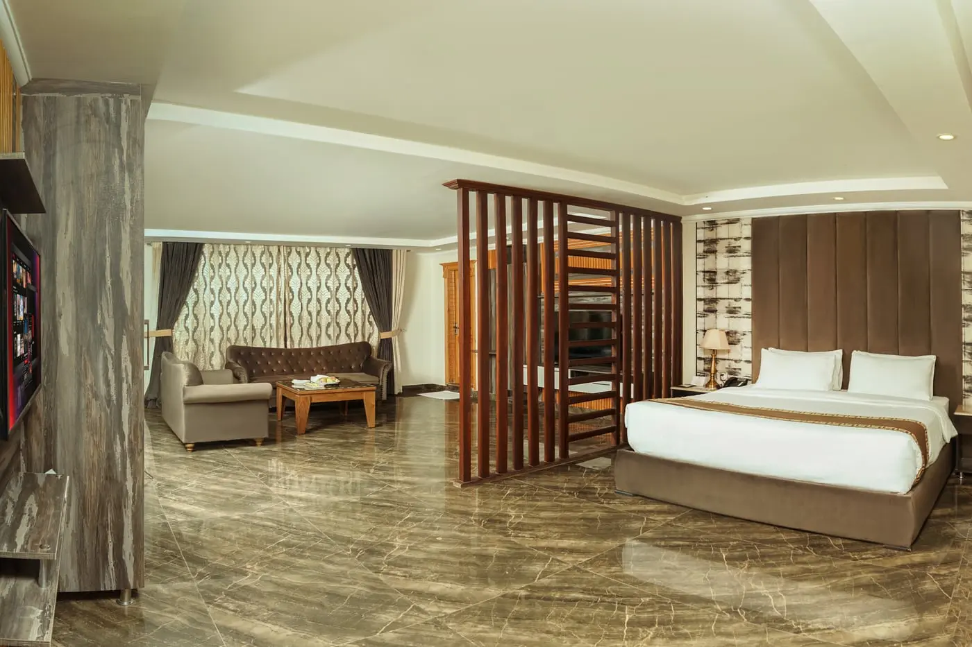A suite with a slatted divider and its own seating area