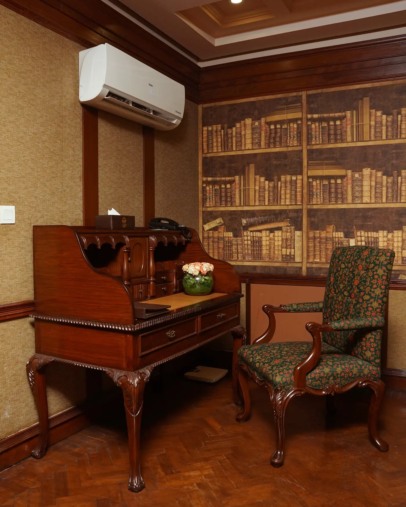 Writing bureau beneath a library mural