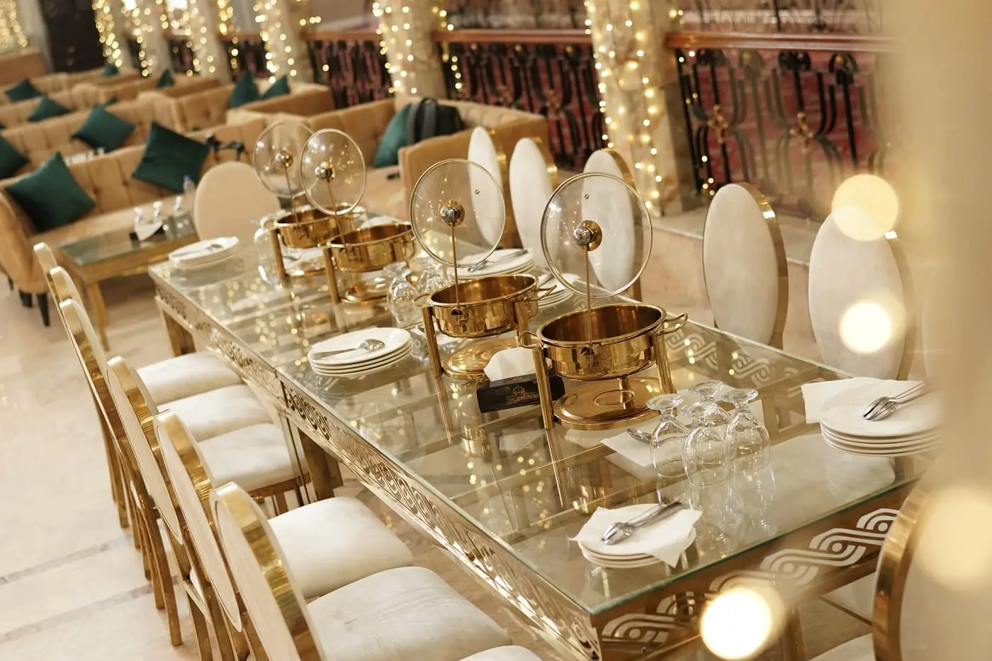 A banquet table laid with chafing dishes