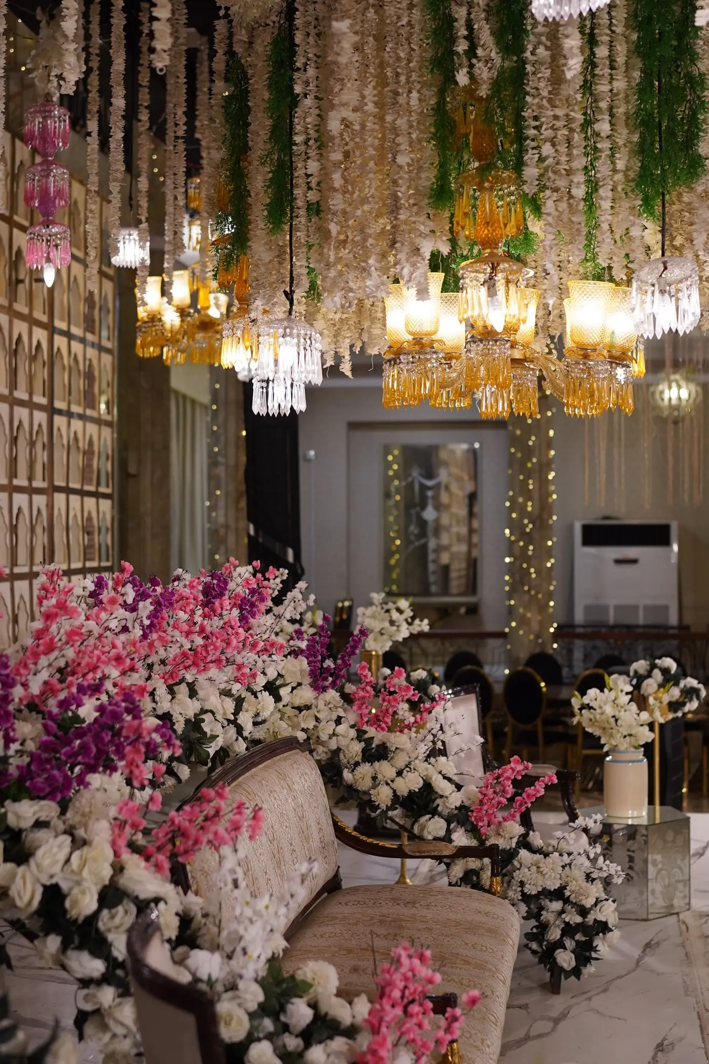 Floral chandeliers above a dressed corner of the hall