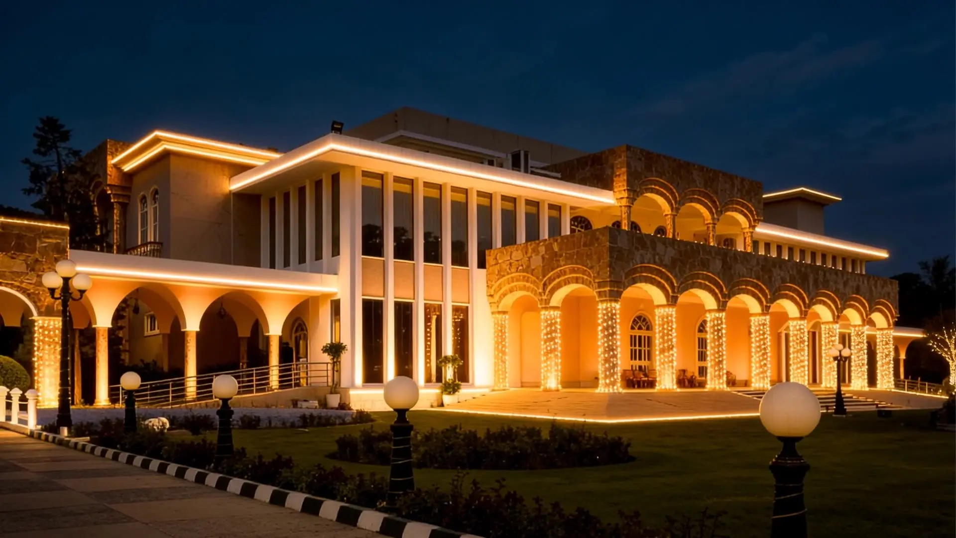 The Palace Banquet at night, its colonnade lit gold behind the lawn